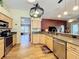 Open-concept kitchen with stainless steel appliances, granite countertops, and hardwood floors, leading to the living room at 748 Andover Cir, Winter Springs, FL 32708