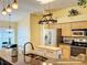 Bright kitchen featuring stainless steel appliances, light wood cabinets, and granite countertops with island at 748 Andover Cir, Winter Springs, FL 32708