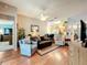 Spacious living room with hardwood floors, a ceiling fan, and access to the kitchen and other rooms at 748 Andover Cir, Winter Springs, FL 32708