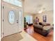 Inviting living room featuring neutral-toned walls, a ceiling fan, and tile entry leading to wood floors at 748 Andover Cir, Winter Springs, FL 32708