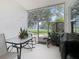 Covered back patio with sliding screen door, table and chairs, plants, and view of backyard at 748 Andover Cir, Winter Springs, FL 32708