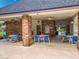 Covered outdoor pool area featuring tables, chairs and brick columns at 748 Andover Cir, Winter Springs, FL 32708