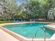 Enjoy poolside relaxation in this outdoor pool surrounded by mature trees at 748 Andover Cir, Winter Springs, FL 32708