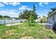 Lush backyard with mature trees, white fencing, and a patio area, perfect for outdoor living at 7807 Pine Hawk Ln, Orlando, FL 32822