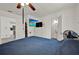 Bedroom with a ceiling fan, dresser, adjacent bathroom, and television at 7807 Pine Hawk Ln, Orlando, FL 32822