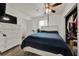 Comfortable bedroom with a ceiling fan, wood-look flooring, closet, and adjacent bathroom at 7807 Pine Hawk Ln, Orlando, FL 32822