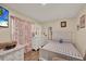Bedroom with a dresser, patterned curtains allowing natural light, and a ceiling television at 7807 Pine Hawk Ln, Orlando, FL 32822