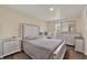Bright bedroom featuring a large dresser, mirror, and comfortable bed at 7807 Pine Hawk Ln, Orlando, FL 32822