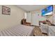 Cozy bedroom with wood-look floors, recliner, and TV for relaxing after a long day at 7807 Pine Hawk Ln, Orlando, FL 32822