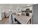 Open layout of a dining area, kitchen, and living room with lots of natural light at 7807 Pine Hawk Ln, Orlando, FL 32822