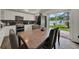 Inviting dining room area adjacent to a modern kitchen with stainless appliances at 7807 Pine Hawk Ln, Orlando, FL 32822