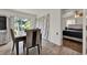 Cozy dining area featuring wood-look floors and access to the bedroom at 7807 Pine Hawk Ln, Orlando, FL 32822