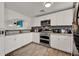 Bright kitchen showcasing white cabinetry, stainless appliances, and stylish backsplash at 7807 Pine Hawk Ln, Orlando, FL 32822