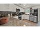 Modern kitchen featuring white cabinets, granite countertops, stainless steel appliances, and wood-look tile flooring at 7807 Pine Hawk Ln, Orlando, FL 32822