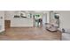 Open-concept living area with wood-look floors and access to kitchen at 7807 Pine Hawk Ln, Orlando, FL 32822