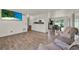 Inviting living area showcasing wood-look floors and access to the kitchen and dining at 7807 Pine Hawk Ln, Orlando, FL 32822