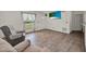 Comfortable living room with wood-look floors, and bright natural light at 7807 Pine Hawk Ln, Orlando, FL 32822
