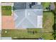 Aerial view of a single-Gathering home with brick driveway, solar panels, and a well-maintained lawn and fenced yard at 8116 Parrot Dr, Orlando, FL 32825