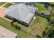 Aerial view of home with solar panels, fenced backyard, and screened patio at 8116 Parrot Dr, Orlando, FL 32825