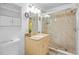 Bathroom featuring a glass-enclosed shower, vanity with storage, granite countertop, and stylish light fixtures at 8116 Parrot Dr, Orlando, FL 32825