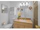 Well-lit bathroom featuring a glass-enclosed shower, vanity with storage, granite countertop, and decorative accents at 8116 Parrot Dr, Orlando, FL 32825