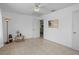 Bedroom features tile flooring, ceiling fan, and a view into an adjacent room at 8116 Parrot Dr, Orlando, FL 32825
