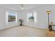 Bright bedroom features tile flooring, ceiling fan, and two windows at 8116 Parrot Dr, Orlando, FL 32825