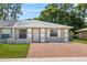 Charming single-story home featuring a well-maintained lawn and inviting brick driveway at 8116 Parrot Dr, Orlando, FL 32825