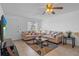 Bright living room with neutral tones, plush seating, tile floors, and a ceiling fan for added comfort at 8116 Parrot Dr, Orlando, FL 32825