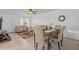 Open-concept living and dining area with neutral decor, tile flooring, comfortable seating, and a stylish dining set at 8116 Parrot Dr, Orlando, FL 32825