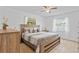 Spacious main bedroom featuring a ceiling fan, windows, wood furniture, and tile flooring for comfort at 8116 Parrot Dr, Orlando, FL 32825