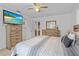 Comfortable bedroom featuring neutral tones, tile flooring, wood furniture, TV, and plenty of storage space at 8116 Parrot Dr, Orlando, FL 32825