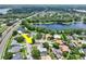 Aerial view of a home in a suburban neighborhood near a lake, highlighting its proximity to nature and other upscale homes at 8248 Marbella View Ct, Orlando, FL 32817