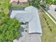 Aerial view of the residence with gray roof, pool, and mature trees at 8248 Marbella View Ct, Orlando, FL 32817