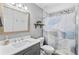 Well-lit bathroom featuring a modern vanity, toilet, and shower with artistic shower curtain, offering comfort and style at 8248 Marbella View Ct, Orlando, FL 32817