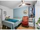 A comfortable bedroom with blue accent wall, ceiling fan, and closet at 8248 Marbella View Ct, Orlando, FL 32817