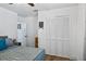 Bedroom with a large closet with folding doors and neutral decor, creating a cozy ambiance at 8248 Marbella View Ct, Orlando, FL 32817