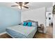 Comfortable bedroom features a queen bed, blue accent wall, and neutral decor, creating a relaxing ambiance at 8248 Marbella View Ct, Orlando, FL 32817