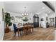Bright dining area features a wooden table with blue accents and a black front door at 8248 Marbella View Ct, Orlando, FL 32817