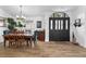 Dining area with wooden table and black front door with glass inserts at 8248 Marbella View Ct, Orlando, FL 32817