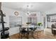 Inviting dining area with modern chandelier, table, and large windows for natural light at 8248 Marbella View Ct, Orlando, FL 32817