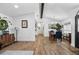 Open floor plan showcasing wood flooring and adjacent dining room at 8248 Marbella View Ct, Orlando, FL 32817
