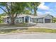 Charming single-story home featuring a gray brick driveway and a lush lawn at 8248 Marbella View Ct, Orlando, FL 32817