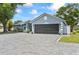 A charming home featuring a paver driveway leading to a spacious garage, showcasing its curb appeal at 8248 Marbella View Ct, Orlando, FL 32817