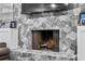 Close-up of a stone fireplace with a mantel and hearth, showcasing the intricate stonework and design at 8248 Marbella View Ct, Orlando, FL 32817