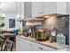 Close-up of the kitchen countertop with granite counters, white cabinets, and a subway tile backsplash at 8248 Marbella View Ct, Orlando, FL 32817