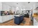 Open kitchen with a center island overlooks the living area with fireplace at 8248 Marbella View Ct, Orlando, FL 32817
