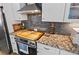 Updated kitchen featuring stainless steel appliances, granite countertops, and stylish gray subway tile backsplash at 8248 Marbella View Ct, Orlando, FL 32817