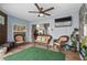 Comfortable lanai with ceiling fan, stone wall detail, and outdoor living space at 8248 Marbella View Ct, Orlando, FL 32817