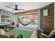 Relaxing screened lanai with stone wall fireplace and backyard pool view at 8248 Marbella View Ct, Orlando, FL 32817